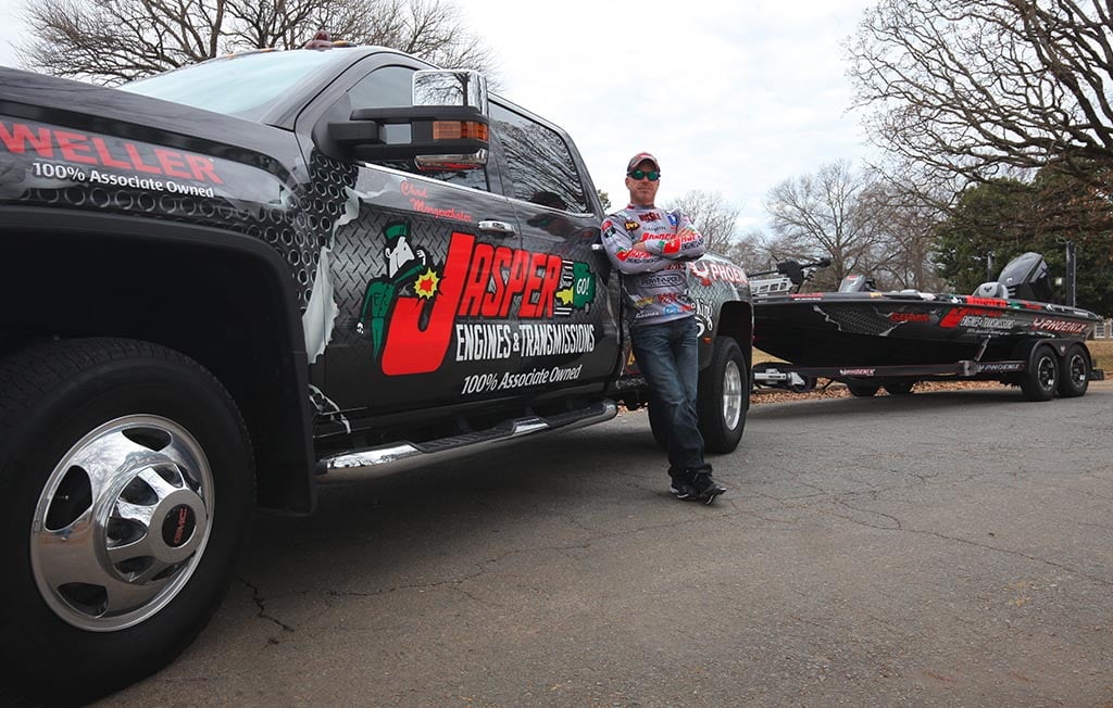Chad Morgenthaler standing by truck and boat